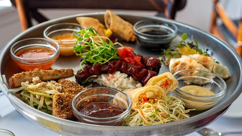Pupu platter with a sampling of egg rolls, spring rolls, dumplings ribs & toast