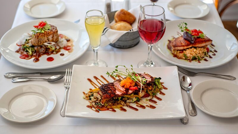 Plated road duck, ahi tuna and roasted salmon entree